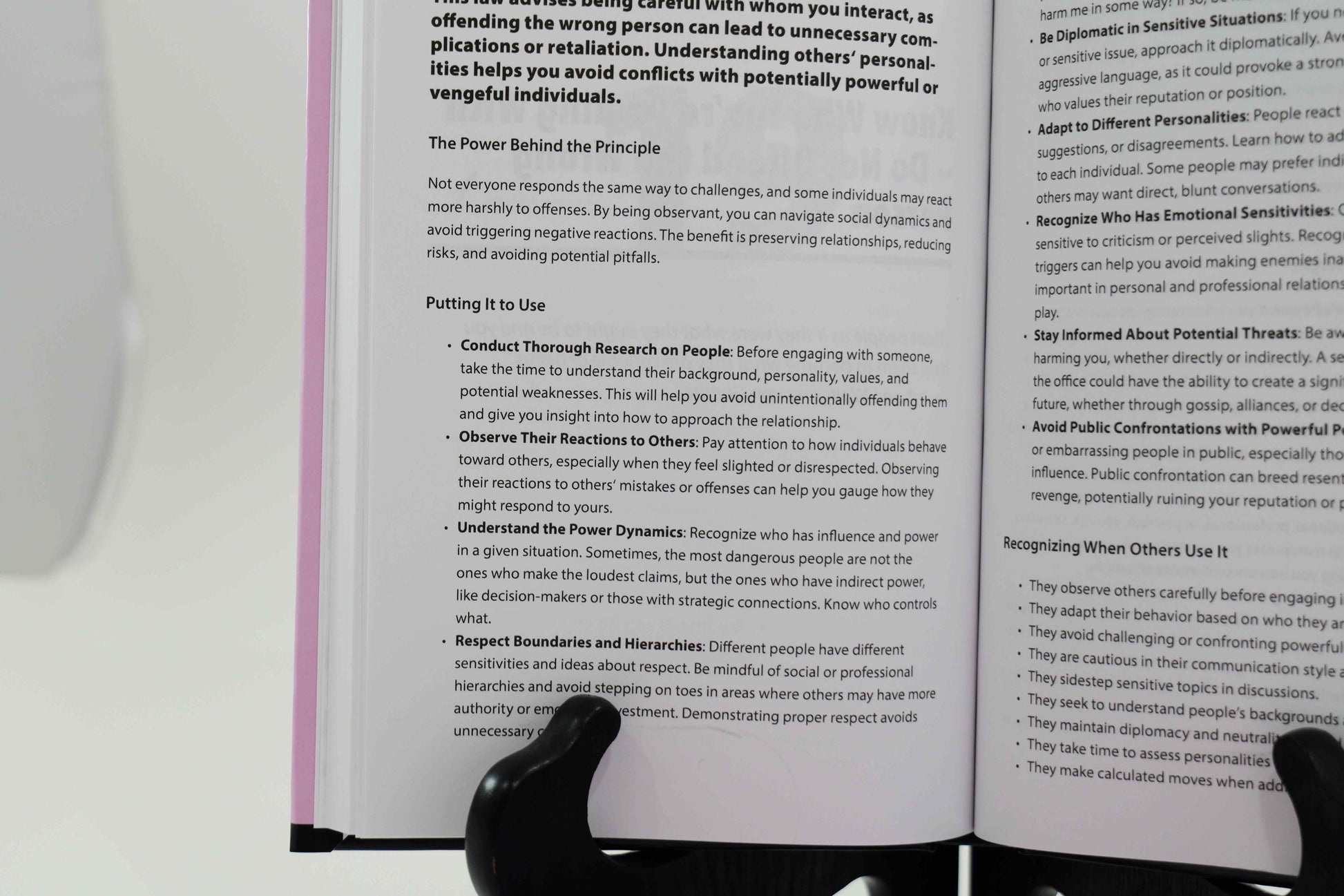 Inside view of book explaining the power behind one of the 48 laws of power, how to put it to use, and how to recognize a powerplay.